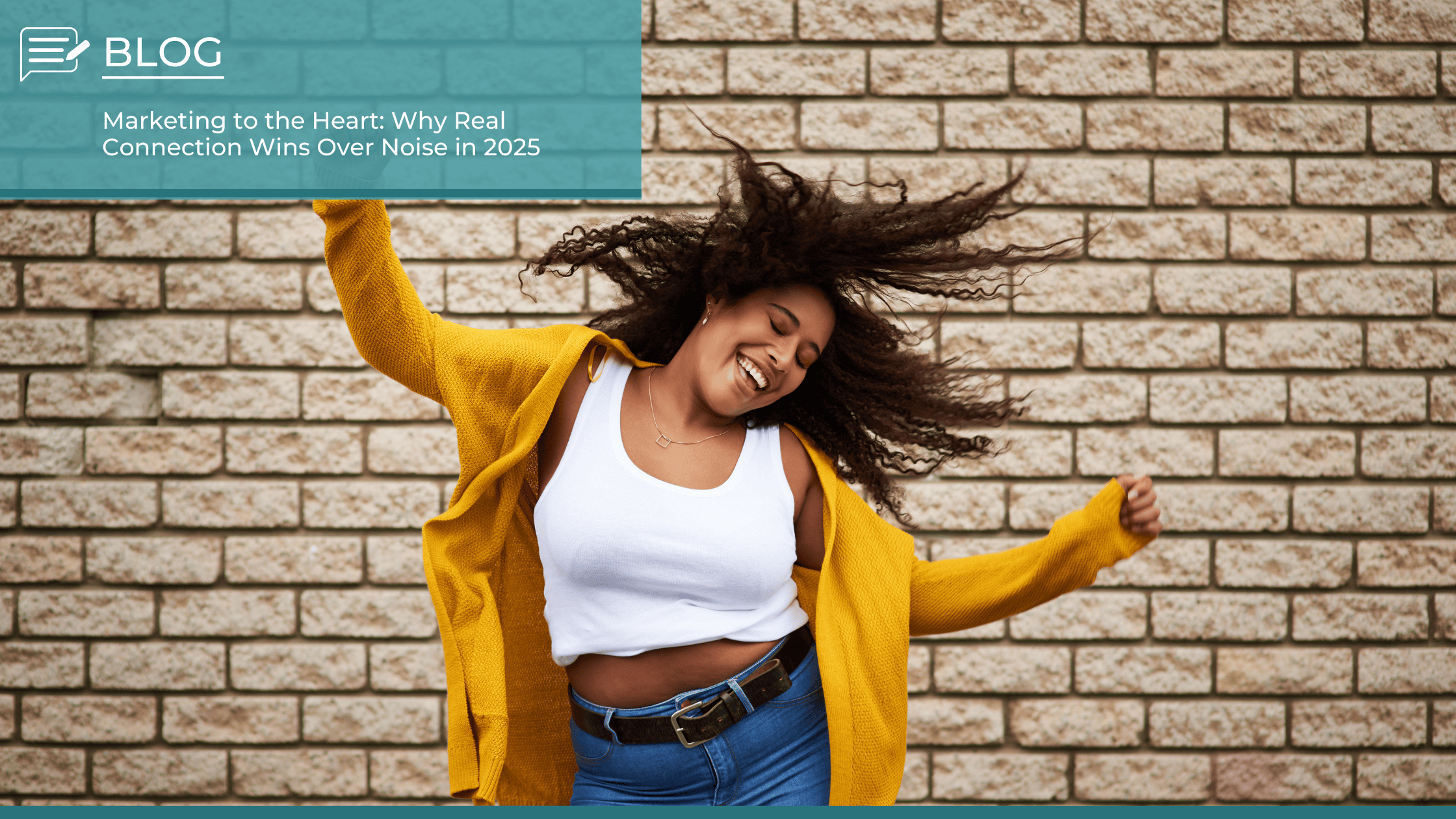 Smiling woman in a yellow cardigan dancing joyfully against a brick wall, symbolising authentic connection in marketing.
