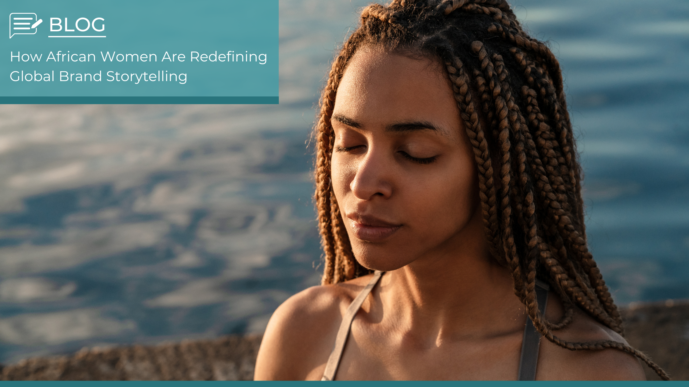 African woman with braided hair sitting peacefully near water, representing cultural heritage and the rise of women in brand storytelling.